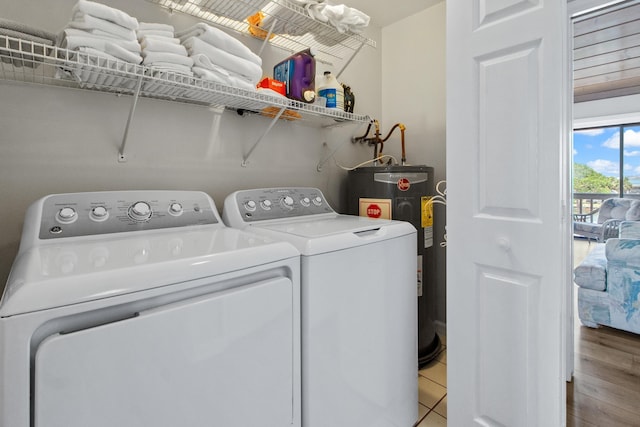 22 Lighthouse Pt, Crawfordville, FL 32327 - laundry room with washer and dryer, water heater, and light tile patterned floors