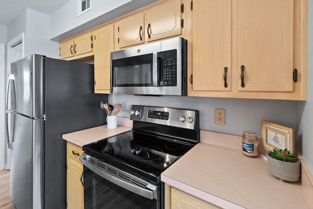 22 Lighthouse Pt, Crawfordville, FL 32327 - kitchen with stainless steel appliances, light countertops, and light brown cabinetry