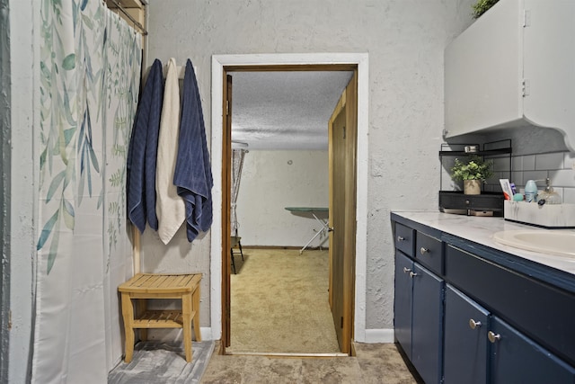 20158 NW Evans Ave, Blountstown, FL 32424 - bathroom featuring a textured ceiling, a textured wall, vanity, curtained shower, and baseboards