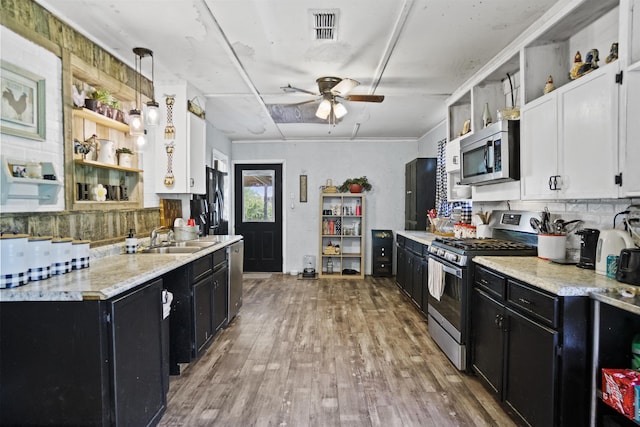 20158 NW Evans Ave, Blountstown, FL 32424 - kitchen with open shelves, appliances with stainless steel finishes, dark cabinetry, and a sink