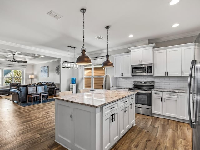 2288 Wabash Trl, Tallahassee, FL 32303 - kitchen with stainless steel appliances, a center island, recessed lighting, white cabinetry, and dark wood-type flooring