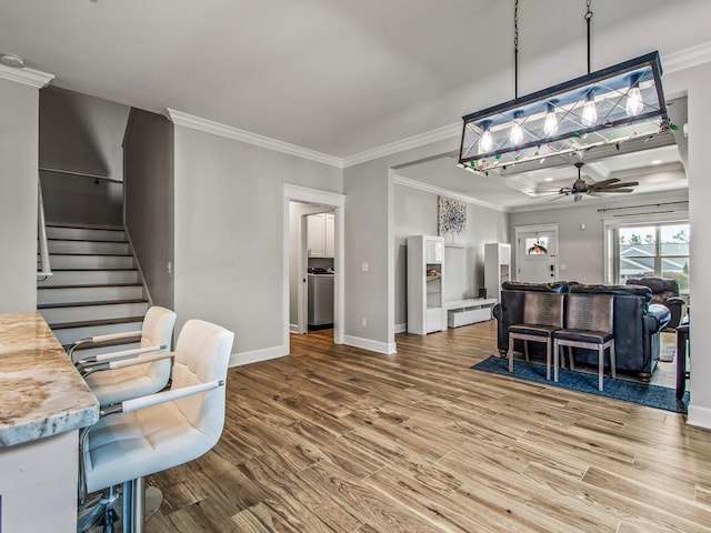 2288 Wabash Trl, Tallahassee, FL 32303 - living area featuring ceiling fan, wood finished floors, crown molding, and stairway