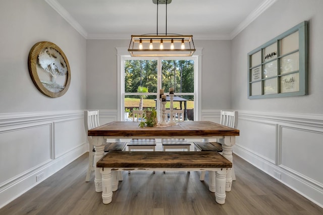 dining area with dark hardwood / wood-style floors and ornamental molding