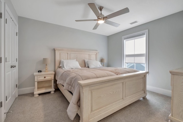 carpeted bedroom featuring a closet and ceiling fan