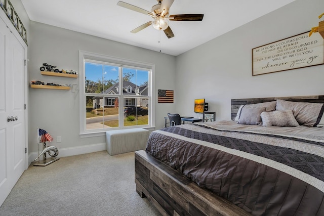 bedroom featuring ceiling fan, light colored carpet, and a closet