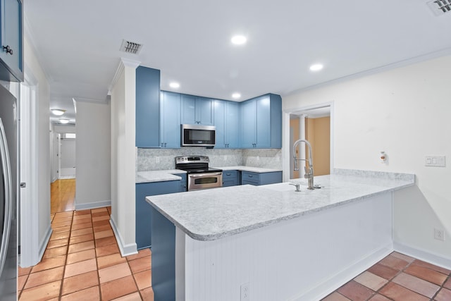 1753 Copperfield Cir, Tallahassee, FL 32312 - kitchen featuring appliances with stainless steel finishes, blue cabinetry, a peninsula, backsplash, and ornamental molding