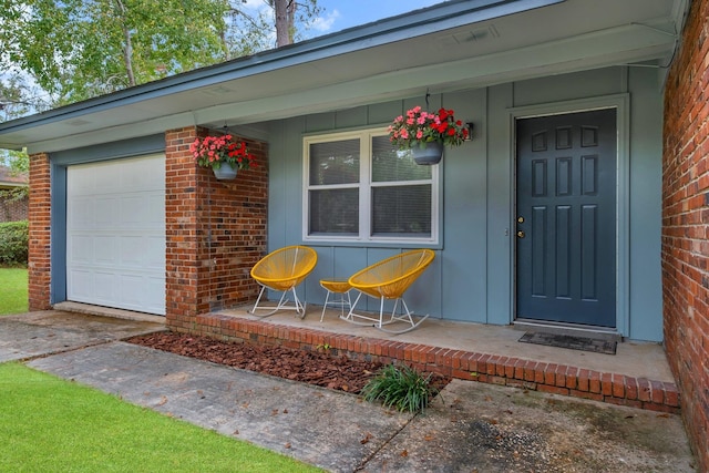 property entrance with a porch and a garage