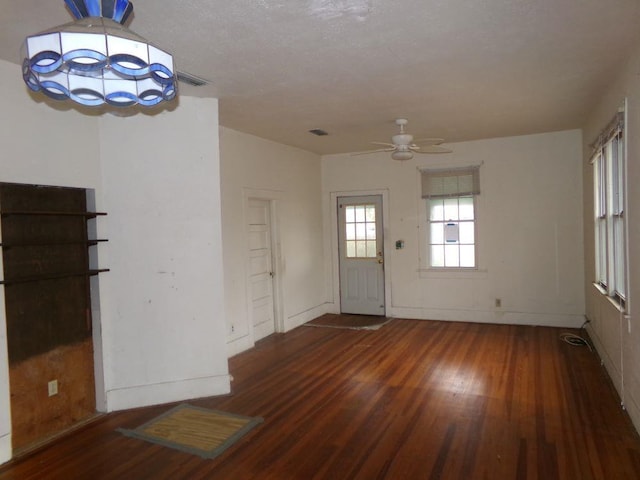 entrance foyer with dark hardwood / wood-style flooring and ceiling fan with notable chandelier