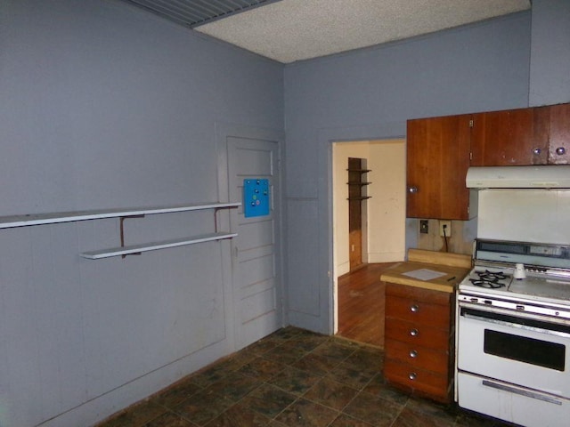 kitchen featuring white gas range and a textured ceiling