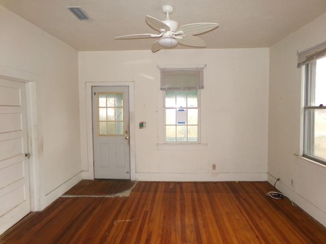 doorway featuring ceiling fan and dark hardwood / wood-style flooring