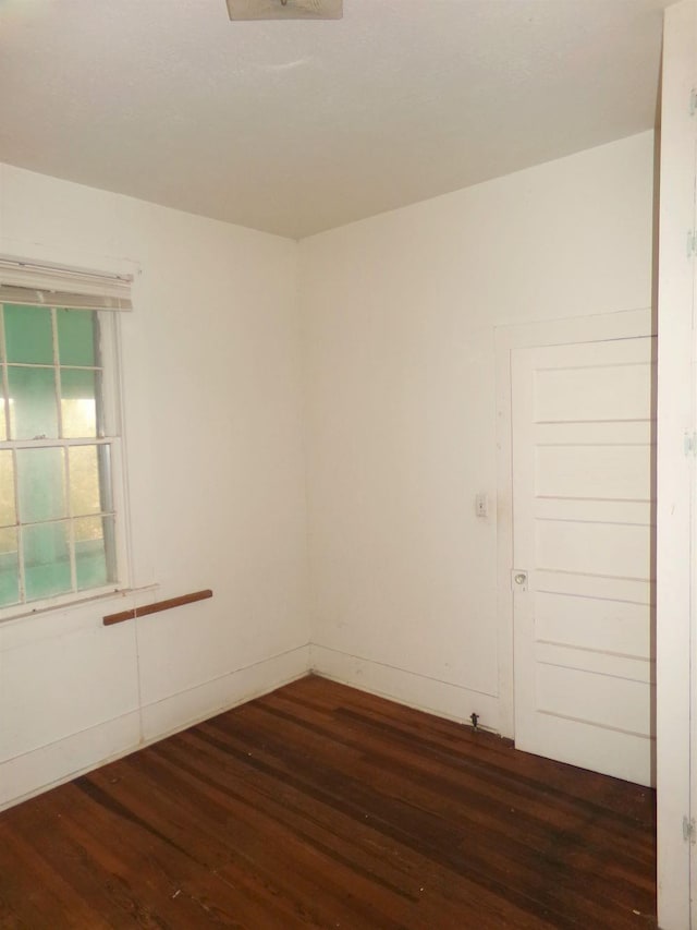 spare room featuring dark hardwood / wood-style flooring