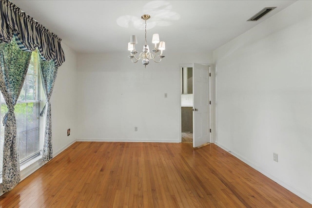711 Kenilworth Rd, Tallahassee, FL 32312 - empty room with a chandelier and wood finished floors