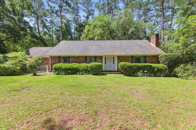 711 Kenilworth Rd, Tallahassee, FL 32312 - single story home with a front yard, a chimney, and brick siding