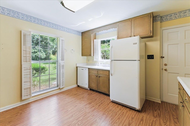 711 Kenilworth Rd, Tallahassee, FL 32312 - kitchen with white appliances, light wood-style flooring, light countertops, and plenty of natural light