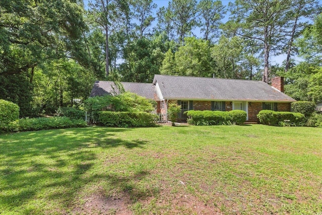 711 Kenilworth Rd, Tallahassee, FL 32312 - single story home with a front lawn, a chimney, and brick siding