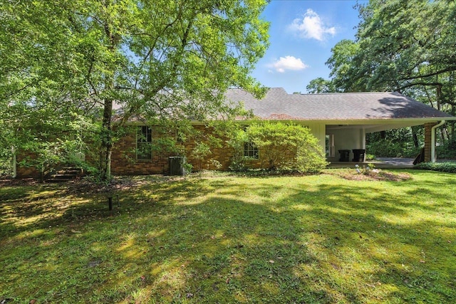 711 Kenilworth Rd, Tallahassee, FL 32312 - back of house with a lawn and an attached carport