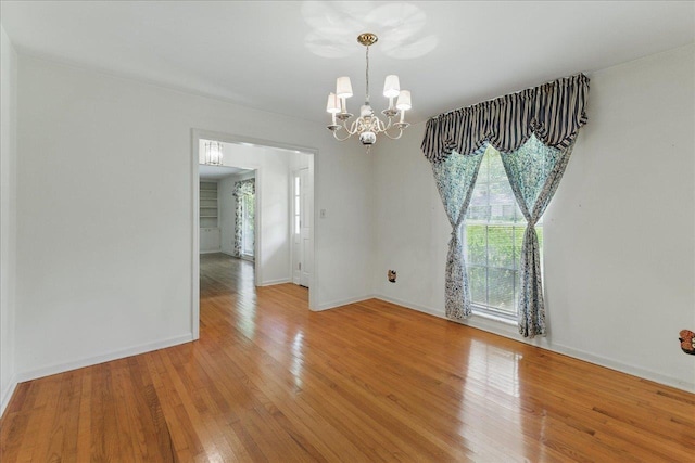 711 Kenilworth Rd, Tallahassee, FL 32312 - empty room with a chandelier, plenty of natural light, and wood finished floors