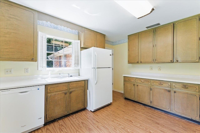 711 Kenilworth Rd, Tallahassee, FL 32312 - kitchen with white appliances, light wood finished floors, light countertops, and brown cabinets