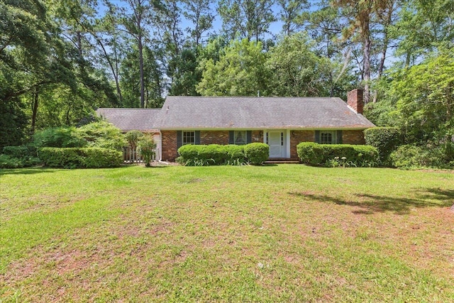711 Kenilworth Rd, Tallahassee, FL 32312 - ranch-style house with a front yard, a chimney, and brick siding