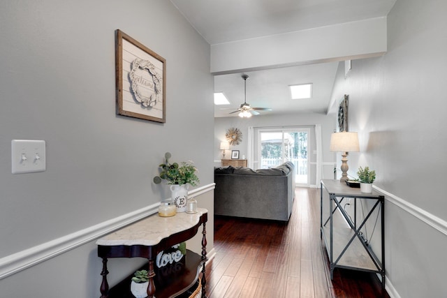 living room with dark hardwood / wood-style flooring and ceiling fan