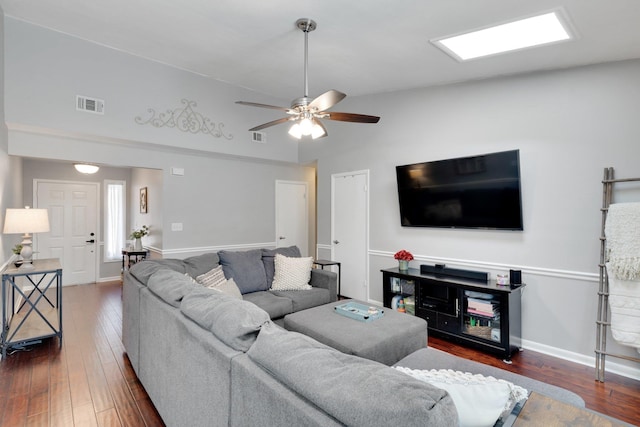 living room with ceiling fan and dark hardwood / wood-style flooring