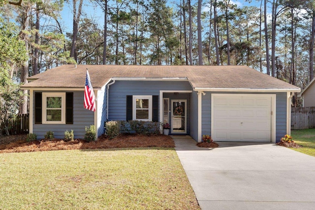 ranch-style house featuring a garage and a front yard