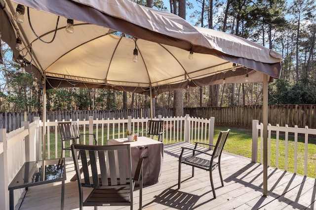 deck featuring a gazebo and a lawn