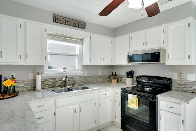 kitchen featuring white cabinetry, black electric range, and sink