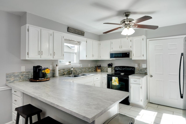 kitchen with stainless steel appliances, white cabinetry, sink, and kitchen peninsula