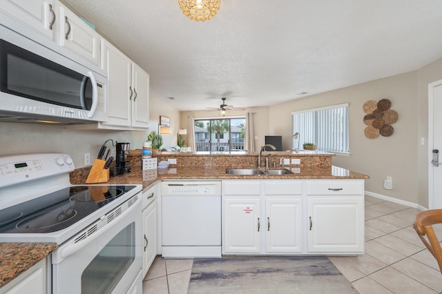 285 Payne Street 23B, Walton Beaches, FL 32550 - kitchen featuring white appliances, a sink, a peninsula, light tile patterned flooring, and a ceiling fan