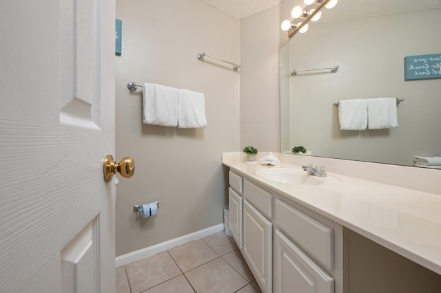 285 Payne Street 23B, Walton Beaches, FL 32550 - bathroom with vanity, tile patterned floors, baseboards, and a textured ceiling