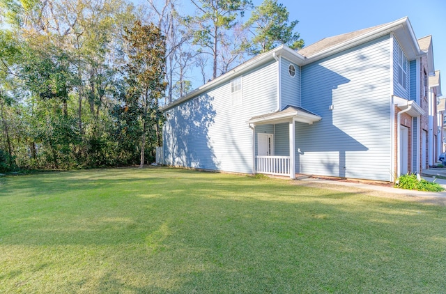 exterior space featuring a garage and a lawn