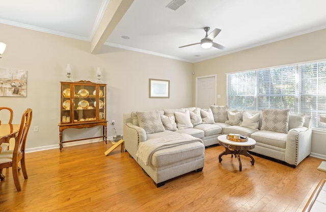 living room featuring ceiling fan, ornamental molding, beam ceiling, and light hardwood / wood-style floors