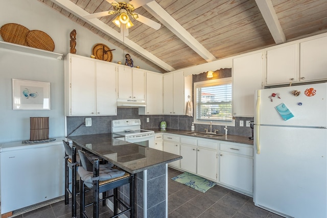 kitchen featuring vaulted ceiling with beams, dark tile patterned floors, white cabinetry, kitchen peninsula, and white appliances