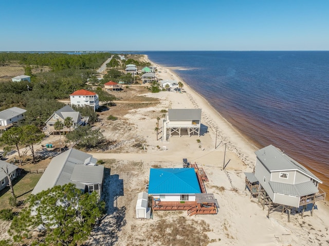 birds eye view of property featuring a view of the beach and a water view