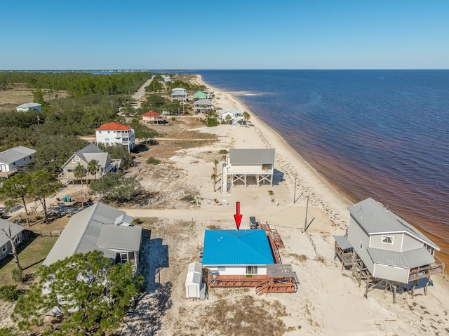 drone / aerial view with a water view and a beach view