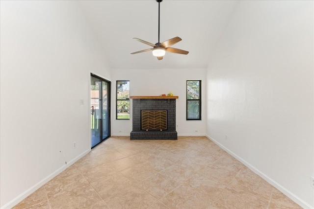 unfurnished living room with a fireplace, ceiling fan, baseboards, and high vaulted ceiling