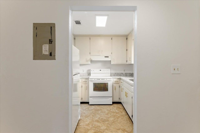 kitchen featuring electric panel, white appliances, visible vents, under cabinet range hood, and light countertops
