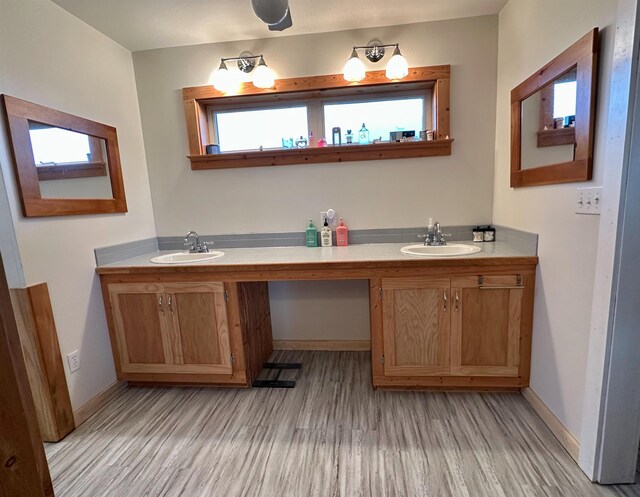 71 Royster Dr, Crawfordville, FL 32327 - full bathroom featuring double vanity, wood finished floors, and baseboards