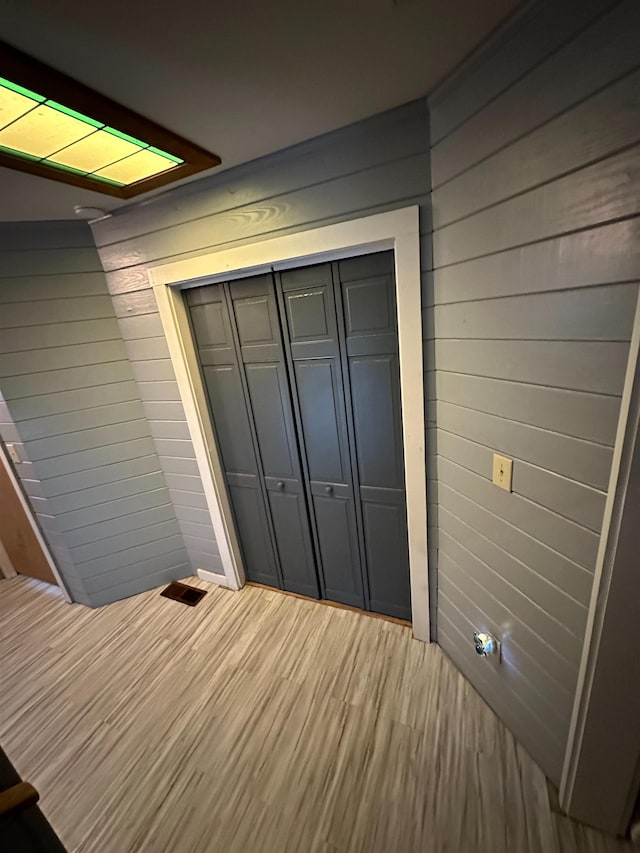 71 Royster Dr, Crawfordville, FL 32327 - unfurnished bedroom with wood walls, a closet, and light wood-type flooring