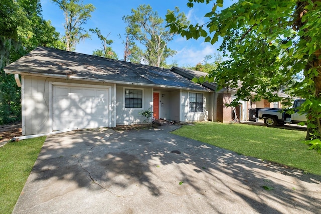 single story home with a garage and a front lawn