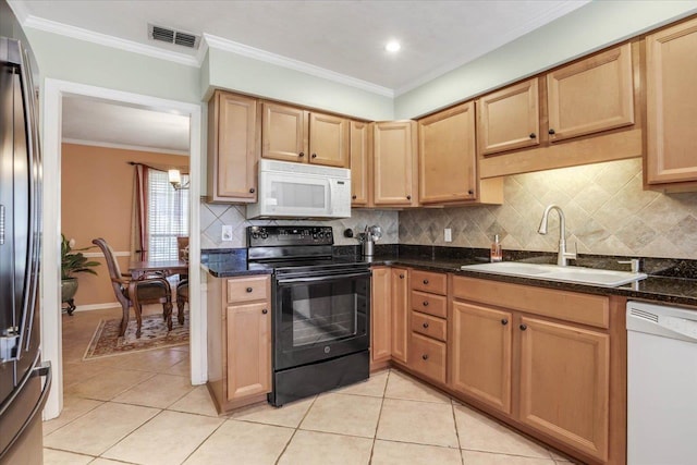 kitchen with white appliances, a sink, visible vents, ornamental molding, and dark stone counters