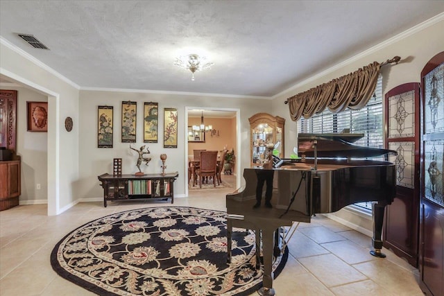 sitting room featuring visible vents, ornamental molding, a textured ceiling, a chandelier, and baseboards