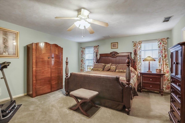 bedroom featuring light carpet, ceiling fan, visible vents, and baseboards