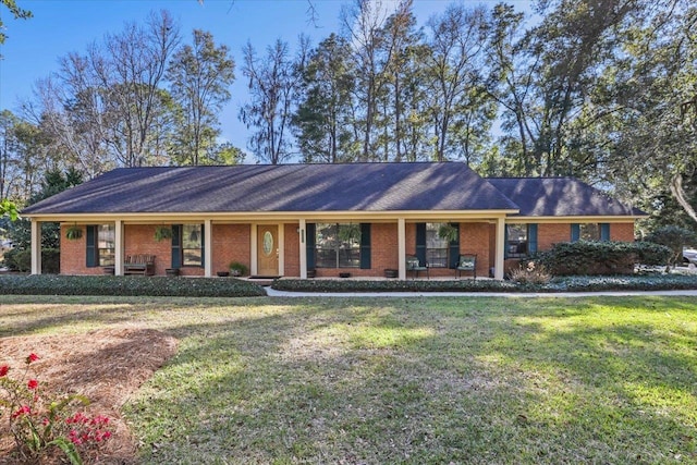 ranch-style home featuring covered porch, a front lawn, and brick siding