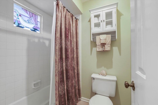 full bathroom featuring shower / tub combo and toilet