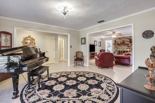 living area with a textured ceiling, a fireplace, visible vents, and crown molding