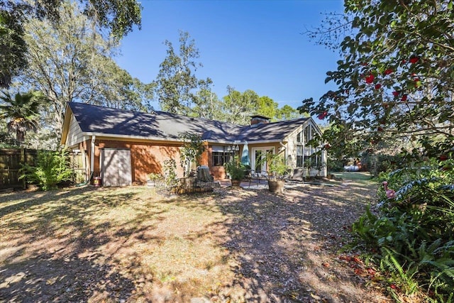 view of front of home with fence and brick siding