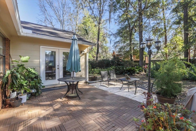 view of patio featuring fence and french doors