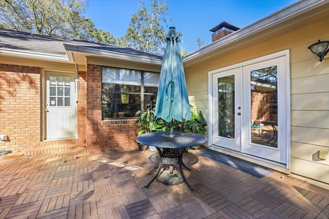 doorway to property with french doors and brick siding